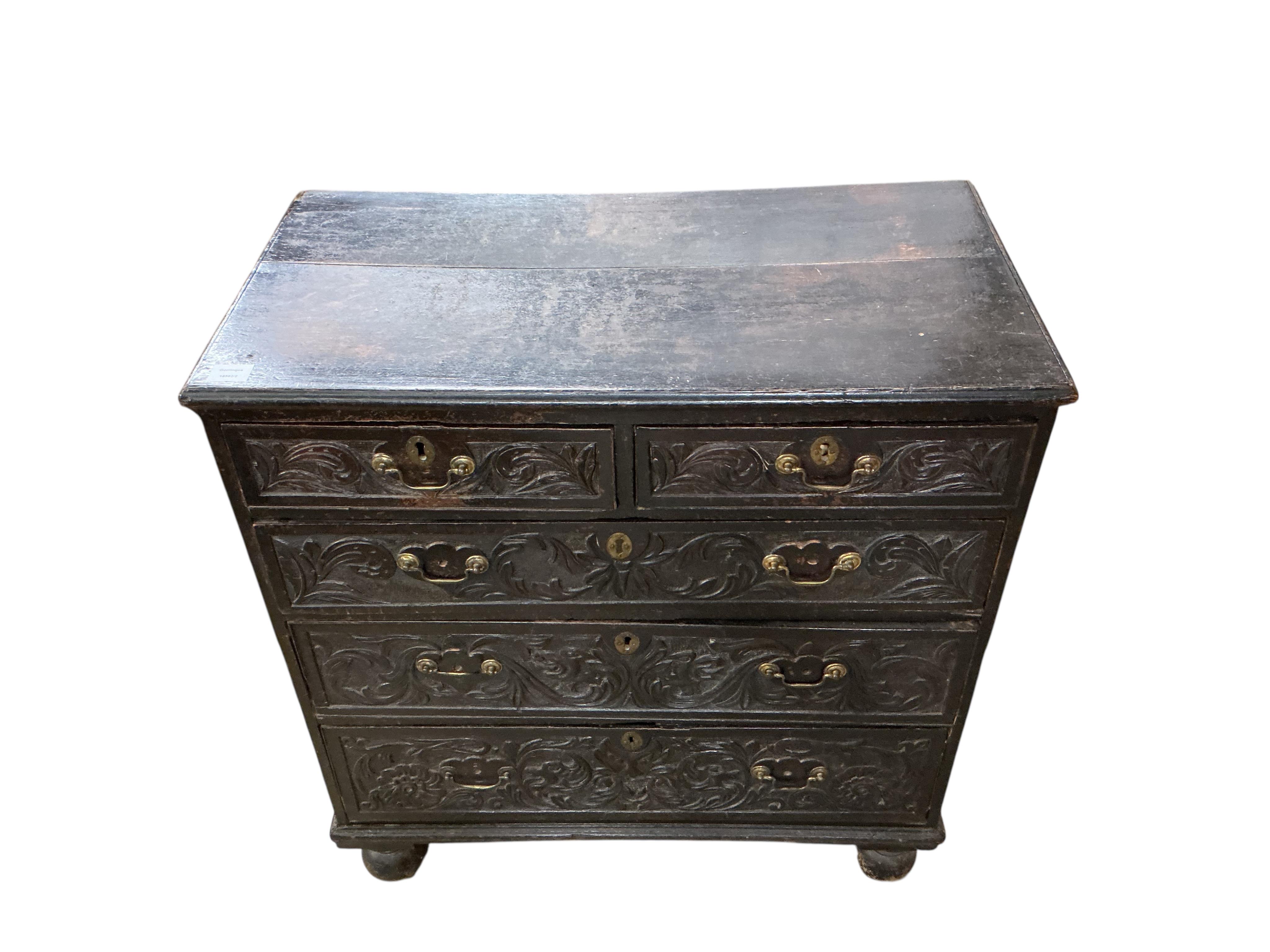 An 18th century oak chest, fitted with two short and three long drawers, later carved, width 89cm, depth 46cm, height 96cm